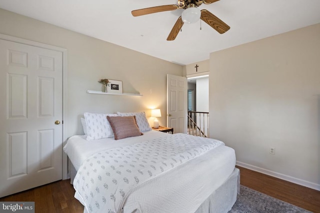  - bedroom featuring wood finished floors, baseboards, and ceiling fan