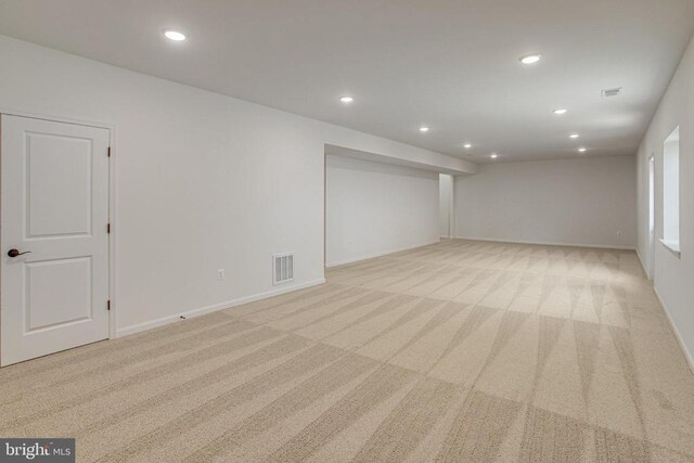 unfurnished room with light colored carpet and recessed lighting