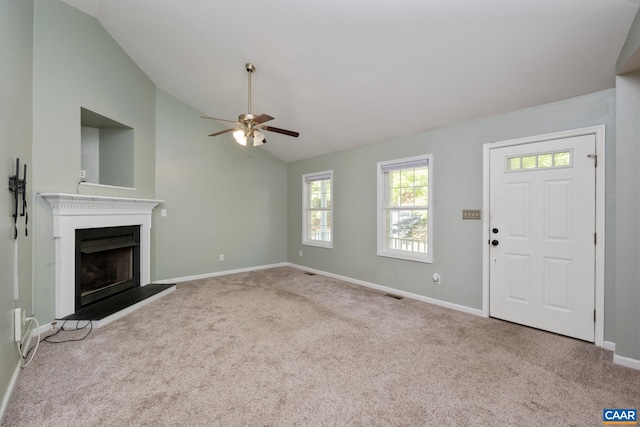 25 Bearwood Dr S, Palmyra, VA 22963 - unfurnished living room featuring carpet, ceiling fan, baseboards, a fireplace with raised hearth, and high vaulted ceiling
