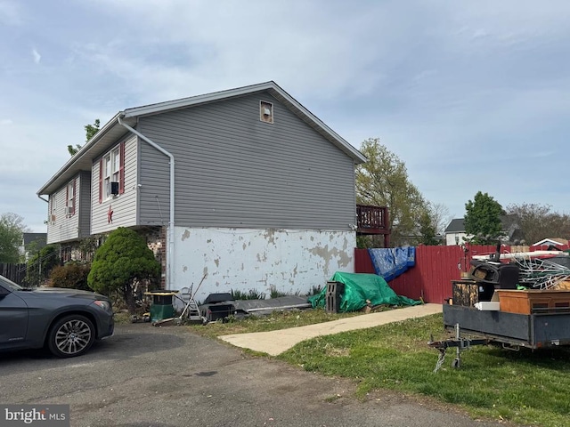 view of home's exterior with cooling unit and fence
