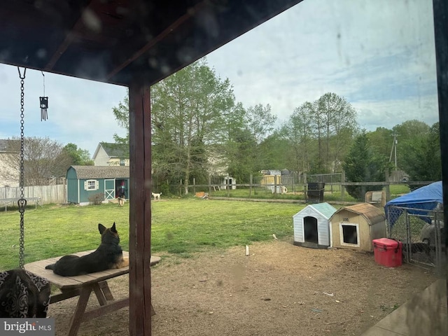 view of yard featuring a shed and an outdoor structure