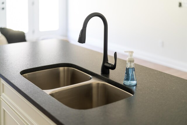 interior details with sink and white cabinets