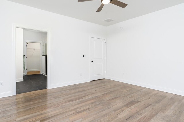 unfurnished bedroom featuring ceiling fan, wood-type flooring, and a closet