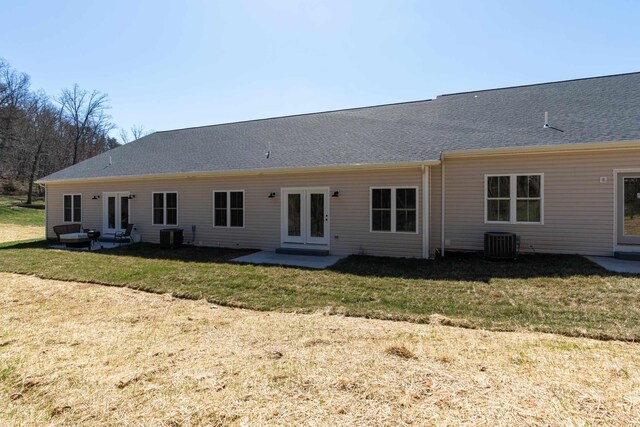 rear view of house featuring a yard, central AC, a patio area, and french doors