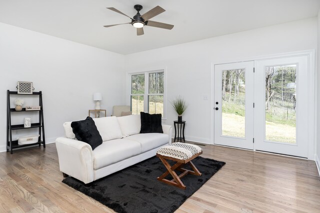 living room with hardwood / wood-style flooring, ceiling fan, and plenty of natural light