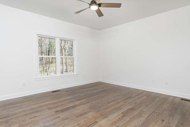 spare room with hardwood / wood-style flooring and ceiling fan