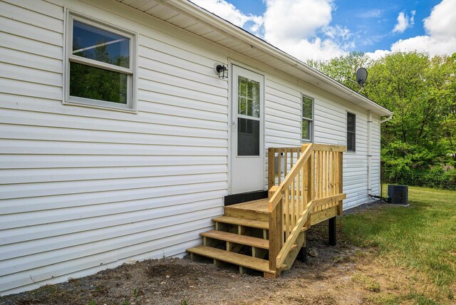 view of exterior entry with a yard