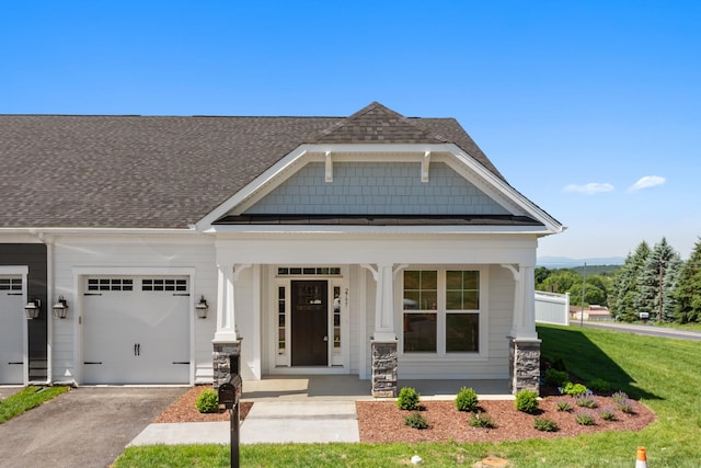 2797 Rutlege Rd Unit 197, Rockingham, VA 22801 - craftsman house with a porch, roof with shingles, asphalt driveway, a garage, and a front yard