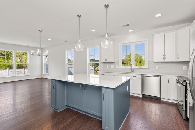 2797 Rutlege Rd Unit 197, Rockingham, VA 22801 - kitchen with appliances with stainless steel finishes, a kitchen island, white cabinetry, dark wood-type flooring, and light countertops