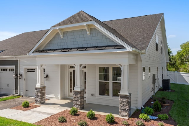 2797 Rutlege Rd Unit 197, Rockingham, VA 22801 - craftsman inspired home with a porch, central AC unit, roof with shingles, a garage, and a standing seam roof