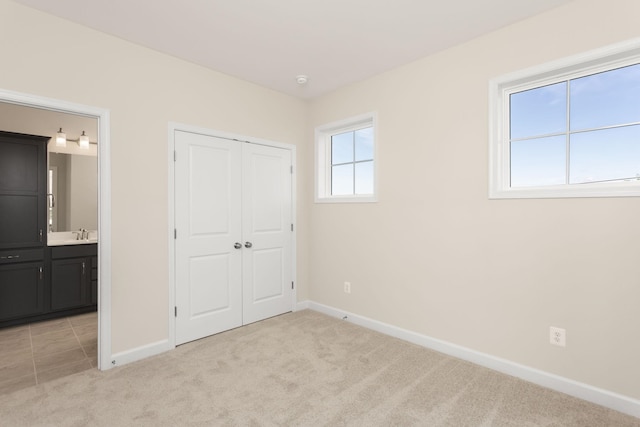 2797 Rutlege Rd Unit 197, Rockingham, VA 22801 - unfurnished bedroom with light carpet, baseboards, a closet, and a sink