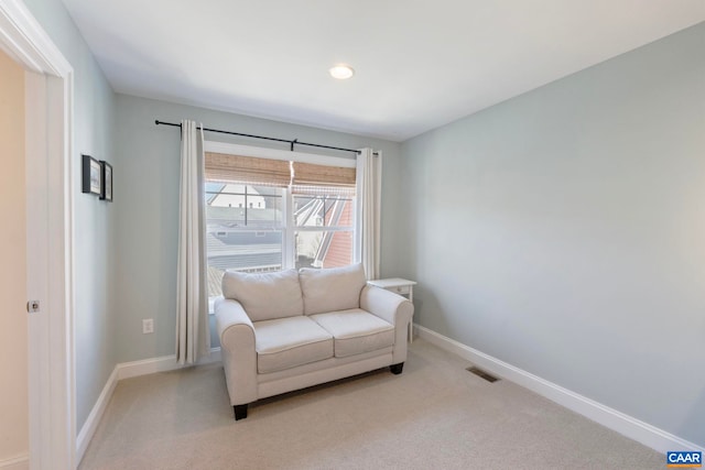 sitting room featuring baseboards, light carpet, and recessed lighting