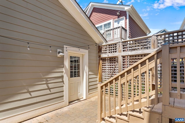 view of exterior entry featuring a wooden deck