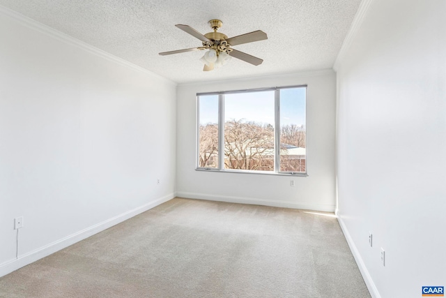 spare room featuring crown molding, a textured ceiling, light colored carpet, and ceiling fan