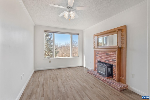 unfurnished living room featuring a textured ceiling, crown molding, wood finished floors, ceiling fan, and baseboards