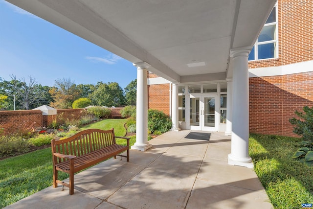 view of patio featuring french doors and fence