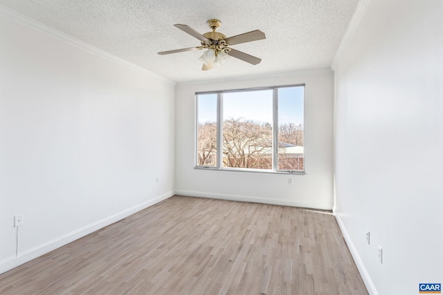 empty room featuring crown molding, a textured ceiling, light wood-style flooring, a ceiling fan, and baseboards