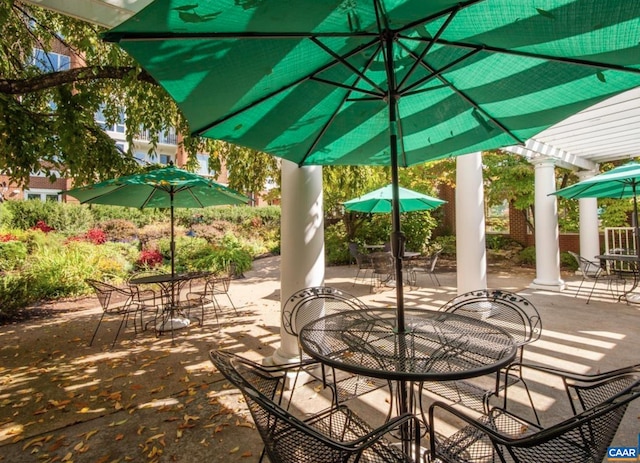 view of patio featuring outdoor dining space and a pergola