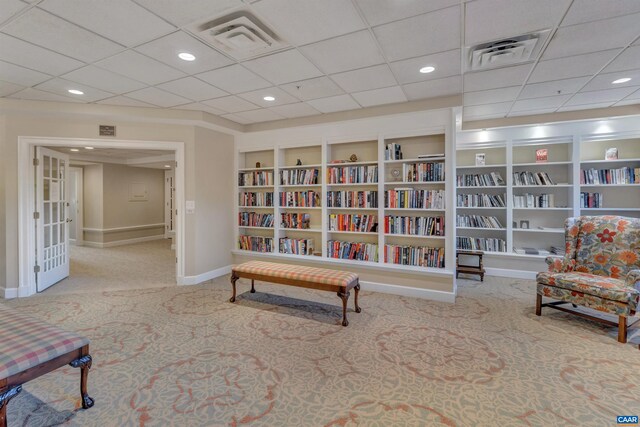 living area with carpet, baseboards, and visible vents