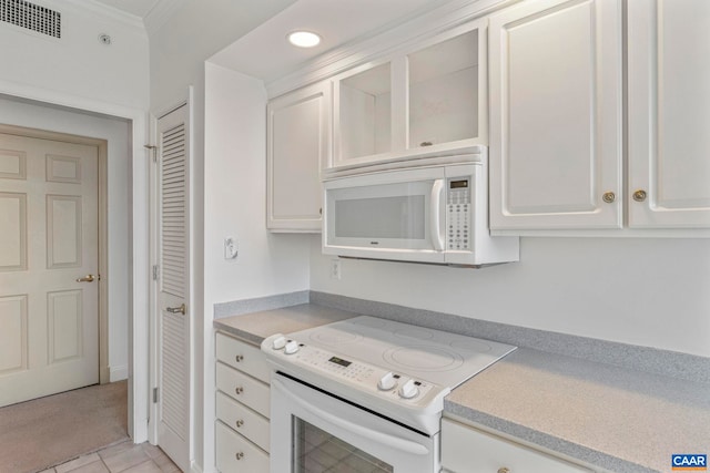 kitchen with white cabinetry, white appliances, light countertops, and visible vents