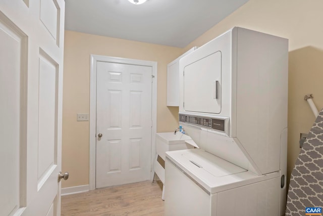 2 Whippoorwill Ln, Palmyra, VA 22963 - laundry area with stacked washing machine and dryer, light wood finished floors, and baseboards