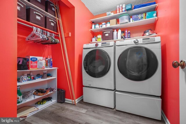 740 Lakeview Pkwy, Locust Grove, VA 22508 - washroom featuring separate washer and dryer, wood finished floors, baseboards, and a textured ceiling