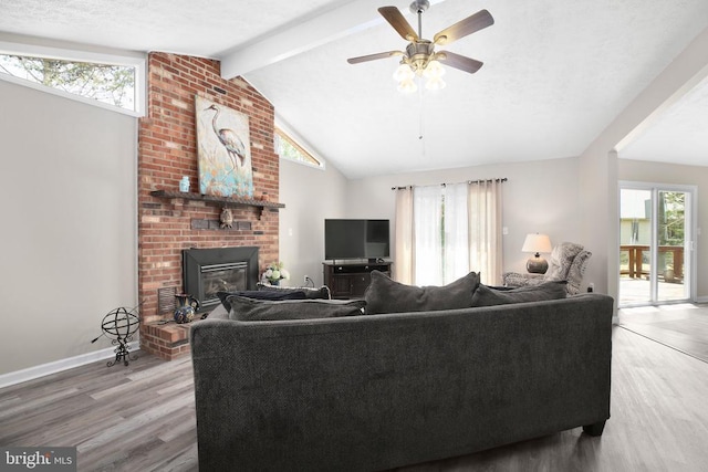740 Lakeview Pkwy, Locust Grove, VA 22508 - living area featuring wood finished floors, a brick fireplace, a ceiling fan, and baseboards