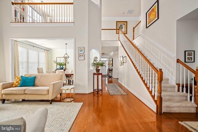 5715 Kesslers Xing W, Fredericksburg, VA 22407 - entrance foyer featuring a towering ceiling, stairs, wood-type flooring, and crown molding