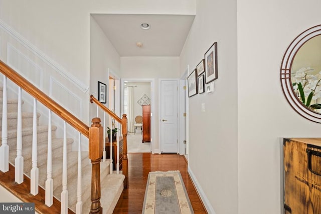 5715 Kesslers Xing W, Fredericksburg, VA 22407 - corridor with dark wood-style floors and stairway