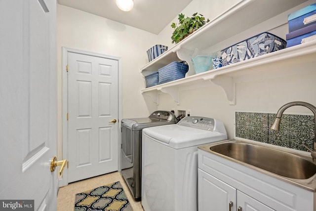 5715 Kesslers Xing W, Fredericksburg, VA 22407 - washroom with washing machine and clothes dryer, cabinet space, and light tile patterned flooring