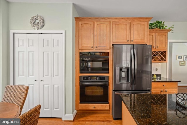 5715 Kesslers Xing W, Fredericksburg, VA 22407 - kitchen featuring stainless steel refrigerator with ice dispenser, light wood-style floors, dark stone countertops, and decorative backsplash