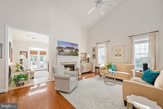 5715 Kesslers Xing W, Fredericksburg, VA 22407 - living room with high vaulted ceiling, hardwood / wood-style flooring, a glass covered fireplace, and a ceiling fan