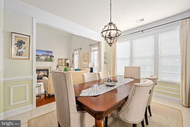 5715 Kesslers Xing W, Fredericksburg, VA 22407 - dining space featuring light tile patterned floors, healthy amount of natural light, a chandelier, and crown molding
