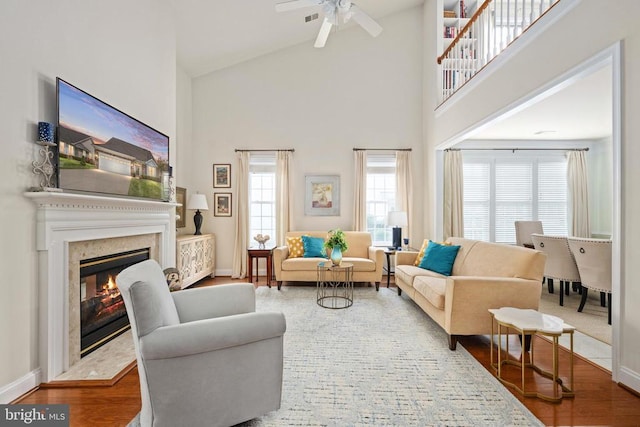 5715 Kesslers Xing W, Fredericksburg, VA 22407 - living area featuring a high end fireplace, high vaulted ceiling, ceiling fan, and wood finished floors