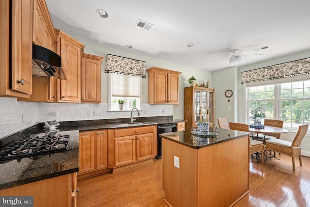 5715 Kesslers Xing W, Fredericksburg, VA 22407 - kitchen with black dishwasher, gas cooktop, extractor fan, light wood-style floors, and a kitchen island