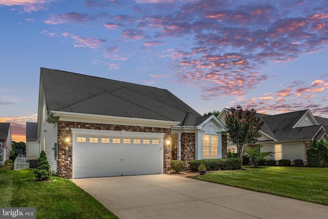 5715 Kesslers Xing W, Fredericksburg, VA 22407 - view of front facade featuring stone siding, driveway, a garage, and a front yard