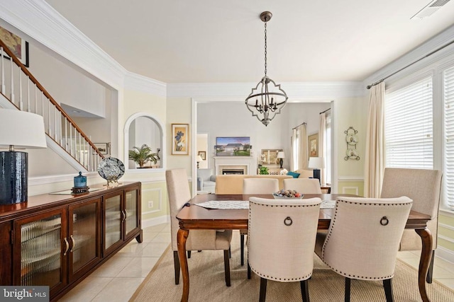 5715 Kesslers Xing W, Fredericksburg, VA 22407 - dining room with light tile patterned floors, a chandelier, wainscoting, stairway, and a fireplace