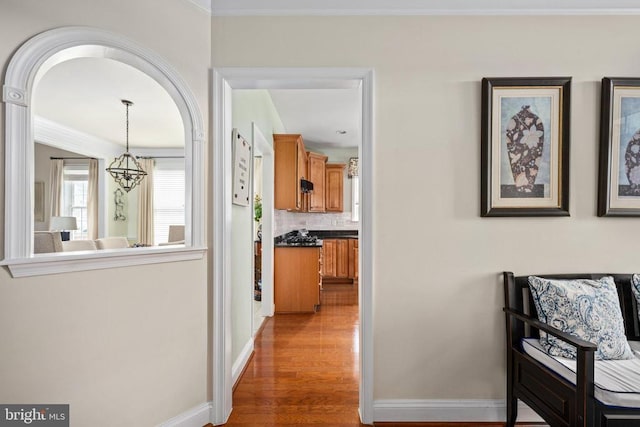 5715 Kesslers Xing W, Fredericksburg, VA 22407 - hallway featuring wood finished floors, a chandelier, and ornamental molding