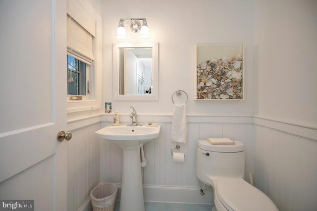 1411 Lakeview Pkwy, Locust Grove, VA 22508 - half bath with wainscoting, toilet, a decorative wall, and a sink