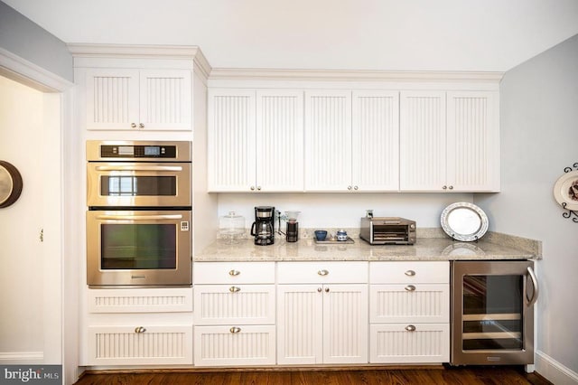 1411 Lakeview Pkwy, Locust Grove, VA 22508 - kitchen with wine cooler, double oven, light stone countertops, and dark wood-style flooring