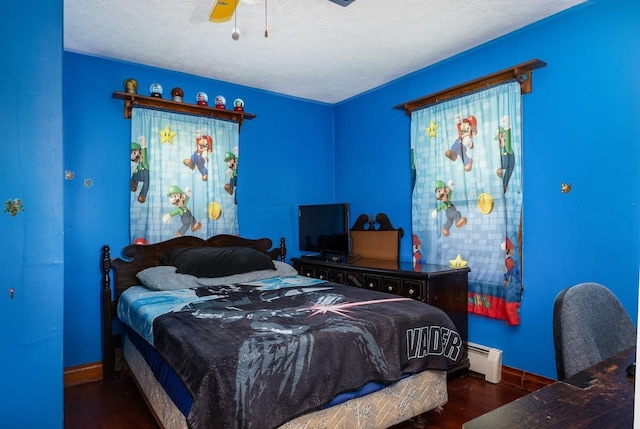 911 Old White Hill Rd, Stuarts Draft, VA 24477 - bedroom featuring wood finished floors, baseboards, a baseboard heating unit, ceiling fan, and a textured ceiling