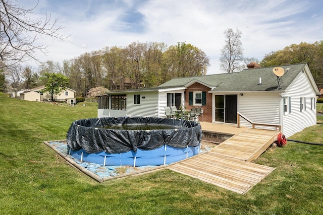 911 Old White Hill Rd, Stuarts Draft, VA 24477 - rear view of property featuring a sunroom, a chimney, a yard, a covered pool, and a shingled roof