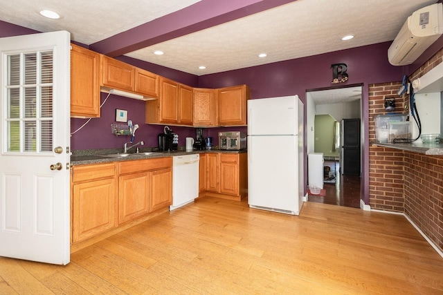 911 Old White Hill Rd, Stuarts Draft, VA 24477 - kitchen with white appliances, a wall mounted air conditioner, light wood-style flooring, dark countertops, and a sink