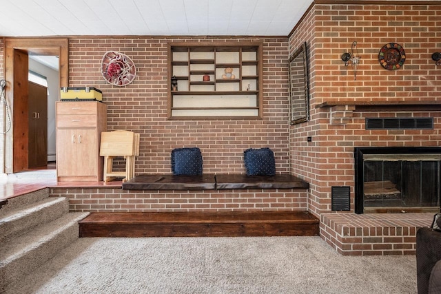 911 Old White Hill Rd, Stuarts Draft, VA 24477 - carpeted living room featuring a brick fireplace, brick wall, and a baseboard radiator