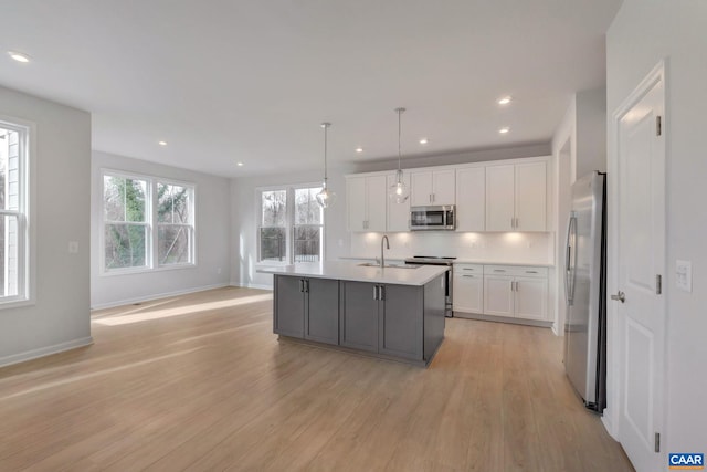 3053 Rambling Brook Ln, Crozet, VA 22932 - kitchen featuring stainless steel appliances, light wood finished floors, light countertops, white cabinetry, and recessed lighting