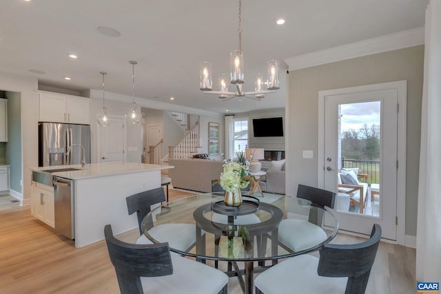 3053 Rambling Brook Ln, Crozet, VA 22932 - dining area featuring crown molding, a chandelier, stairway, light wood finished floors, and recessed lighting