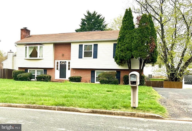802 Shamrock Dr, Fredericksburg, VA 22407 - bi-level home featuring a chimney, a front yard, and brick siding