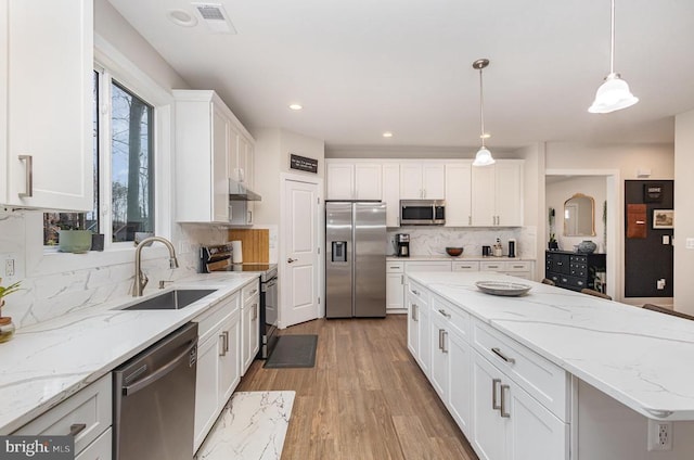 208 Yorktown Blvd, Locust Grove, VA 22508 - kitchen featuring appliances with stainless steel finishes, a sink, under cabinet range hood, decorative backsplash, and white cabinets