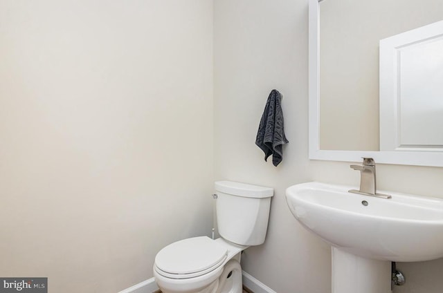 208 Yorktown Blvd, Locust Grove, VA 22508 - bathroom featuring baseboards, toilet, and a sink