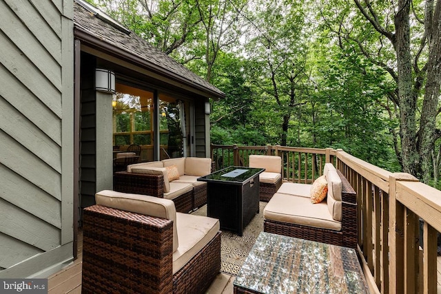 wooden terrace with an outdoor hangout area